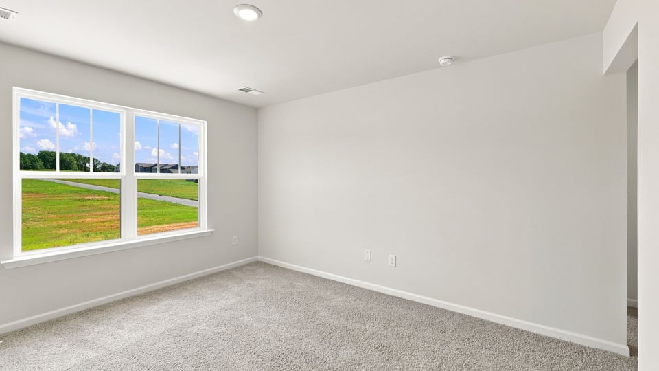 Bedroom with carpet and window.