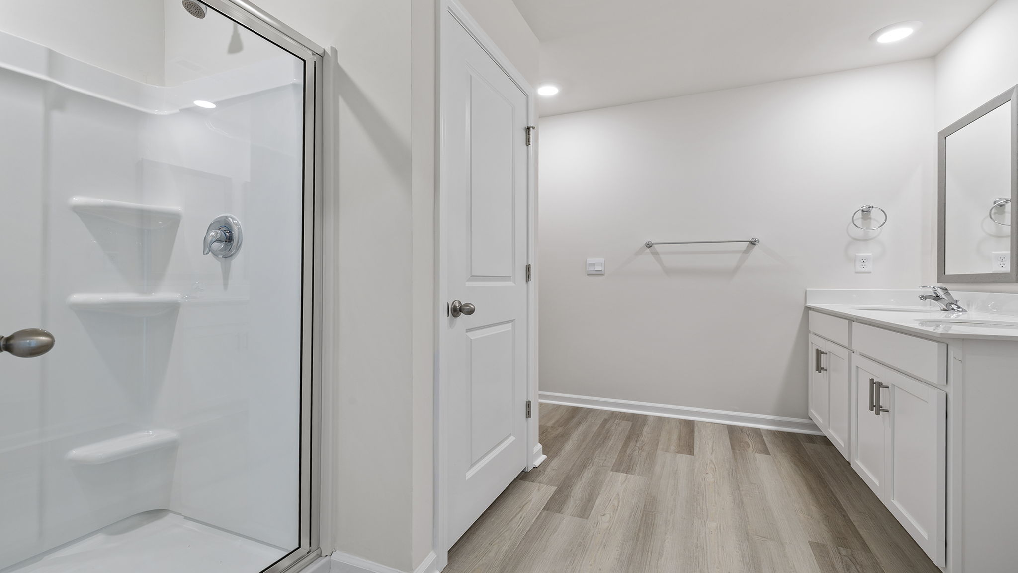 Bathroom with walk in closet and vanity.