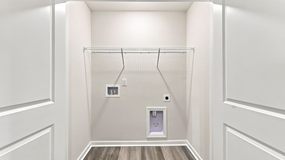 Laundry room with hanging storage racks.