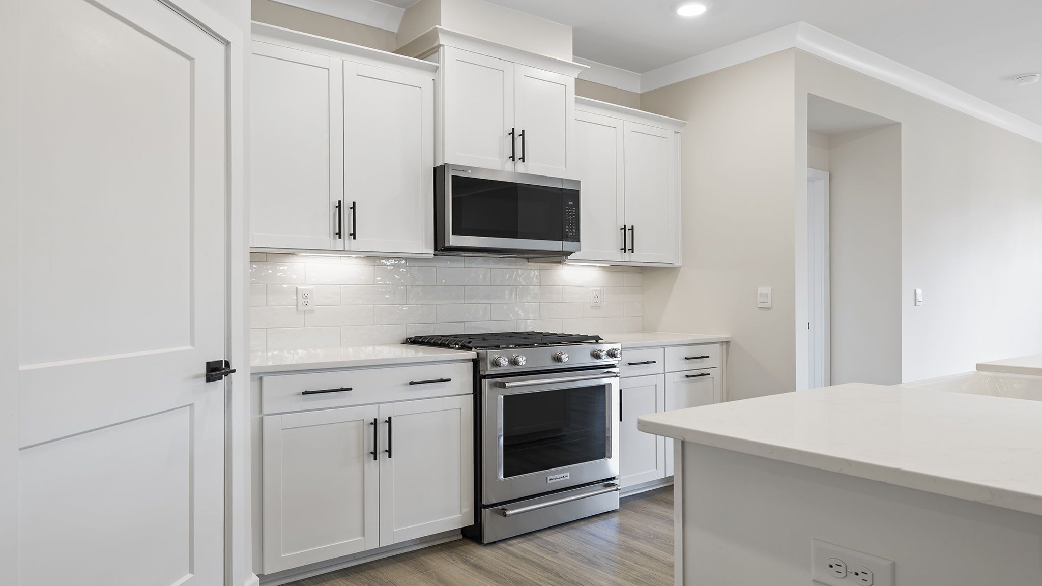 Kitchen features stainless steel appliances and walk-in pantry.