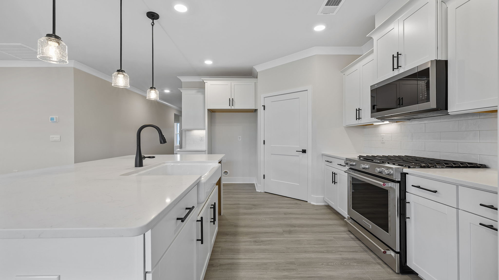 Kitchen and island have quartz countertops.