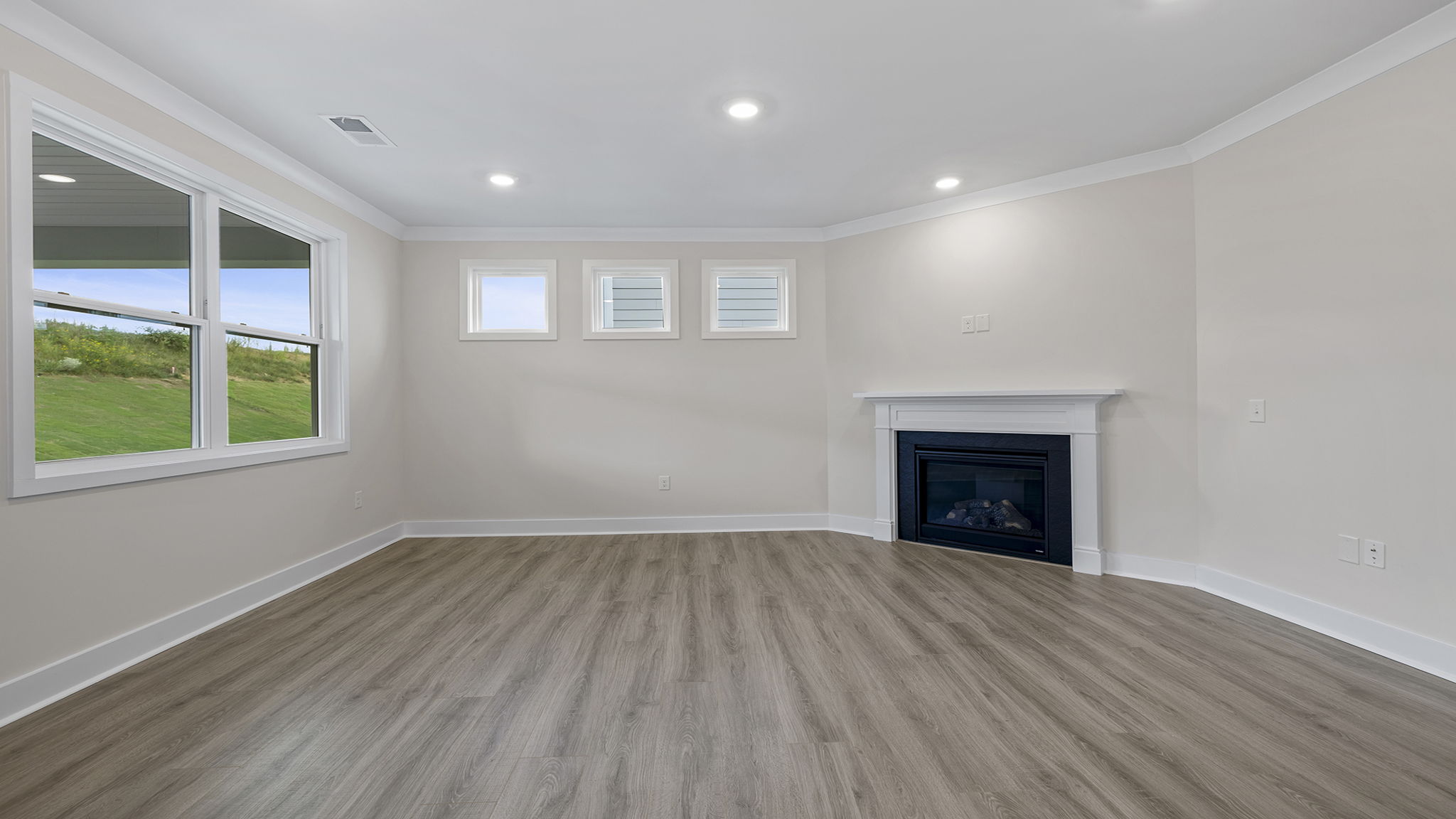Family room with lots of windows and gas log fireplace.