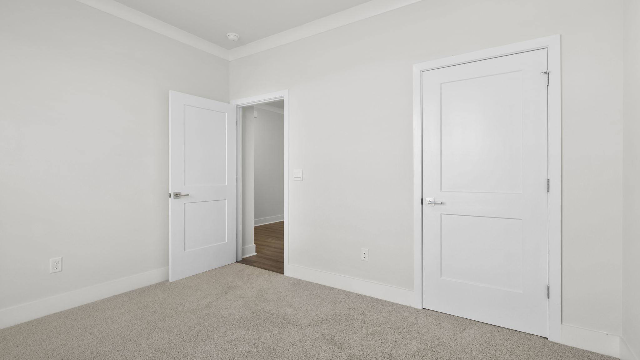 Bedroom with carpet and window.