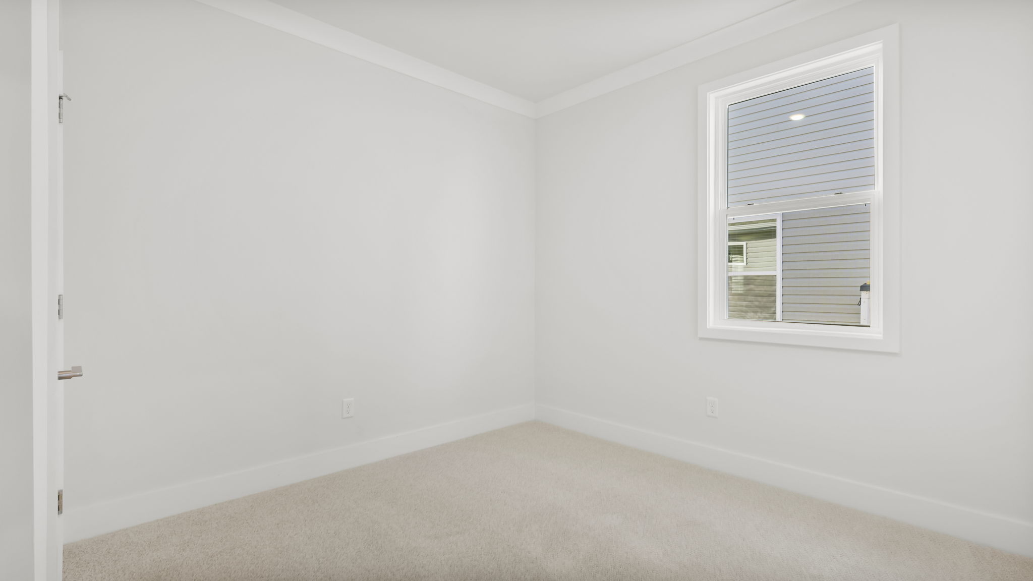Bedroom with carpet and window.