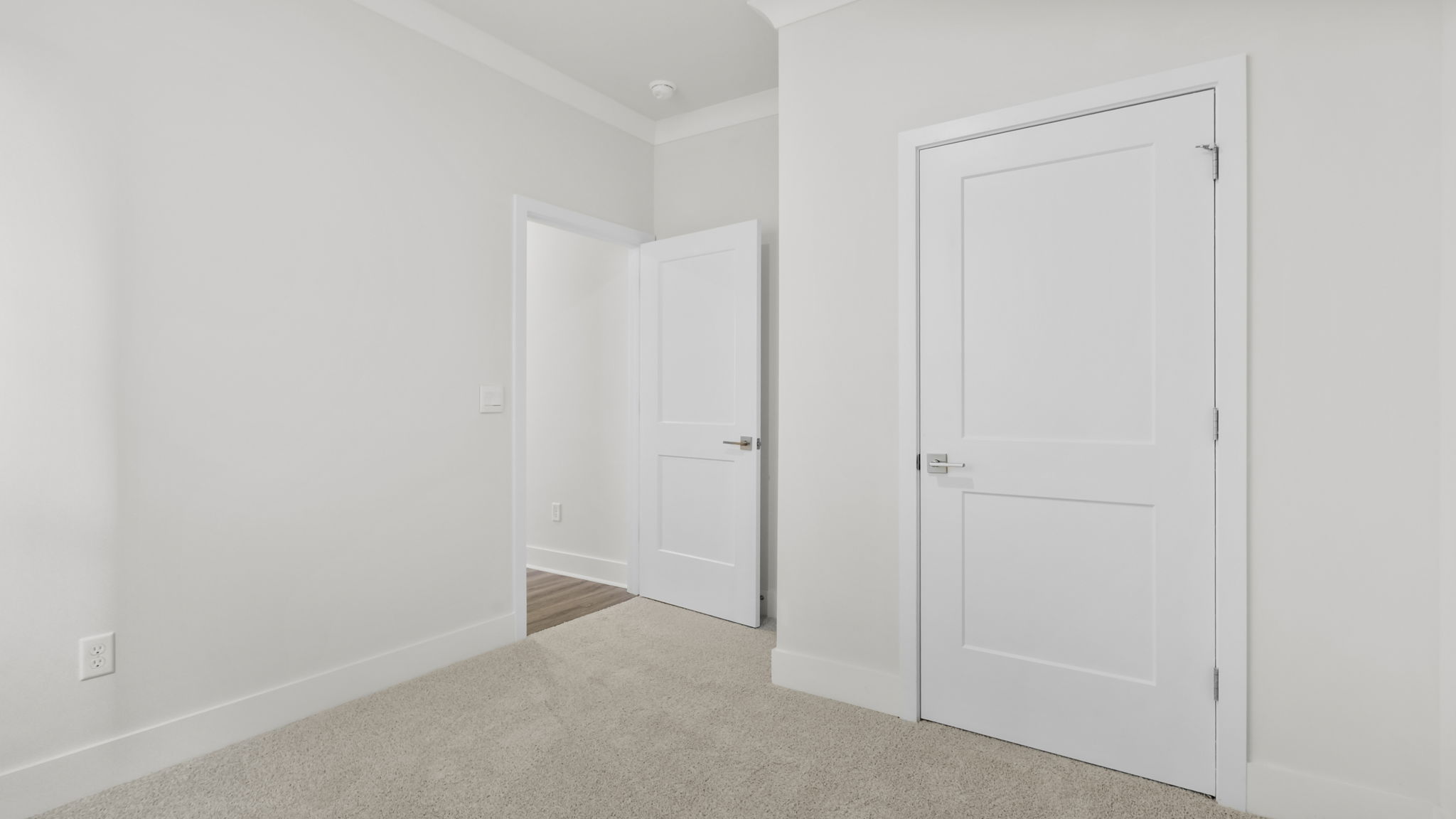 Bedroom with carpet and window.