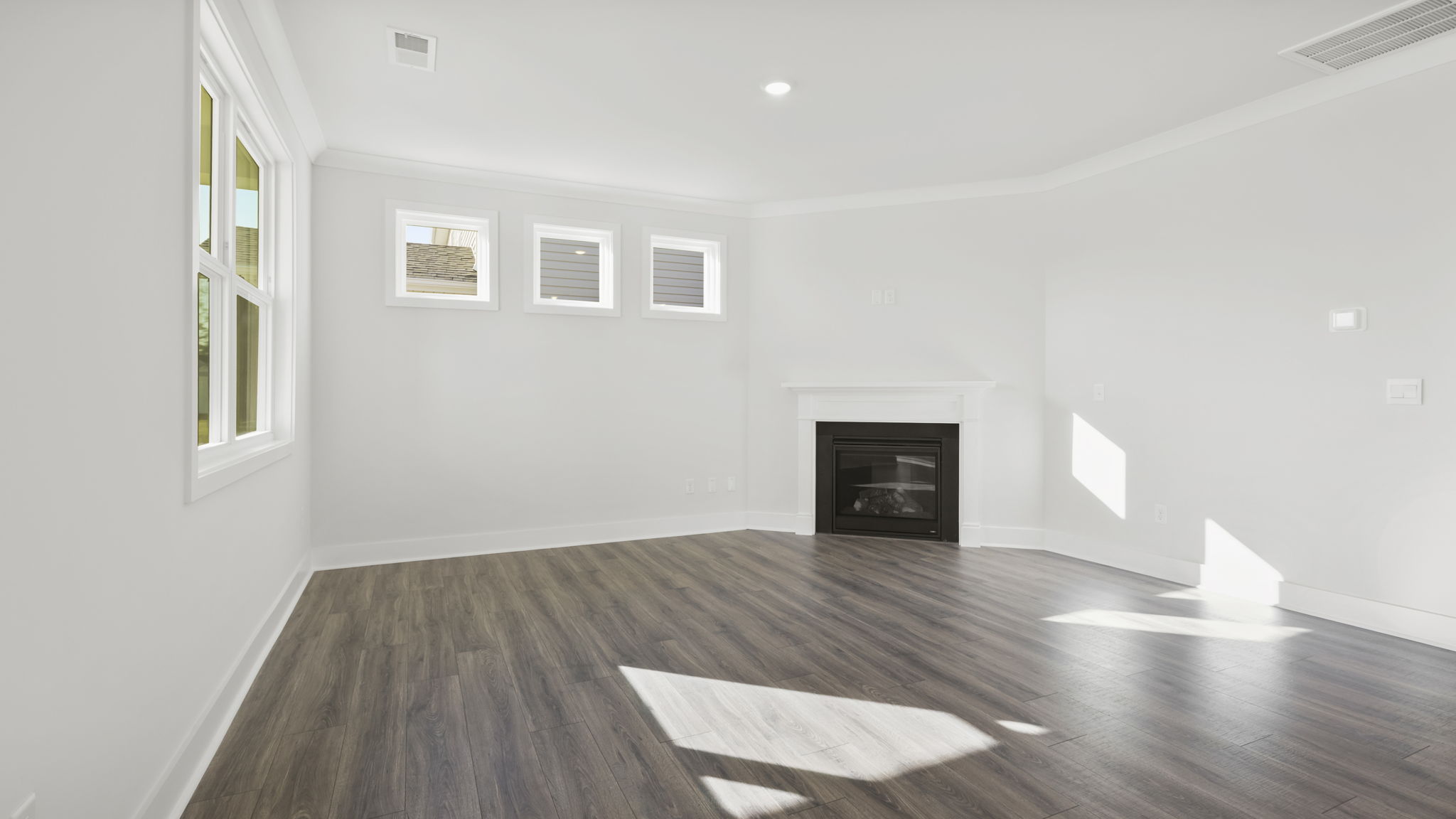 Family room with windows and fireplace.