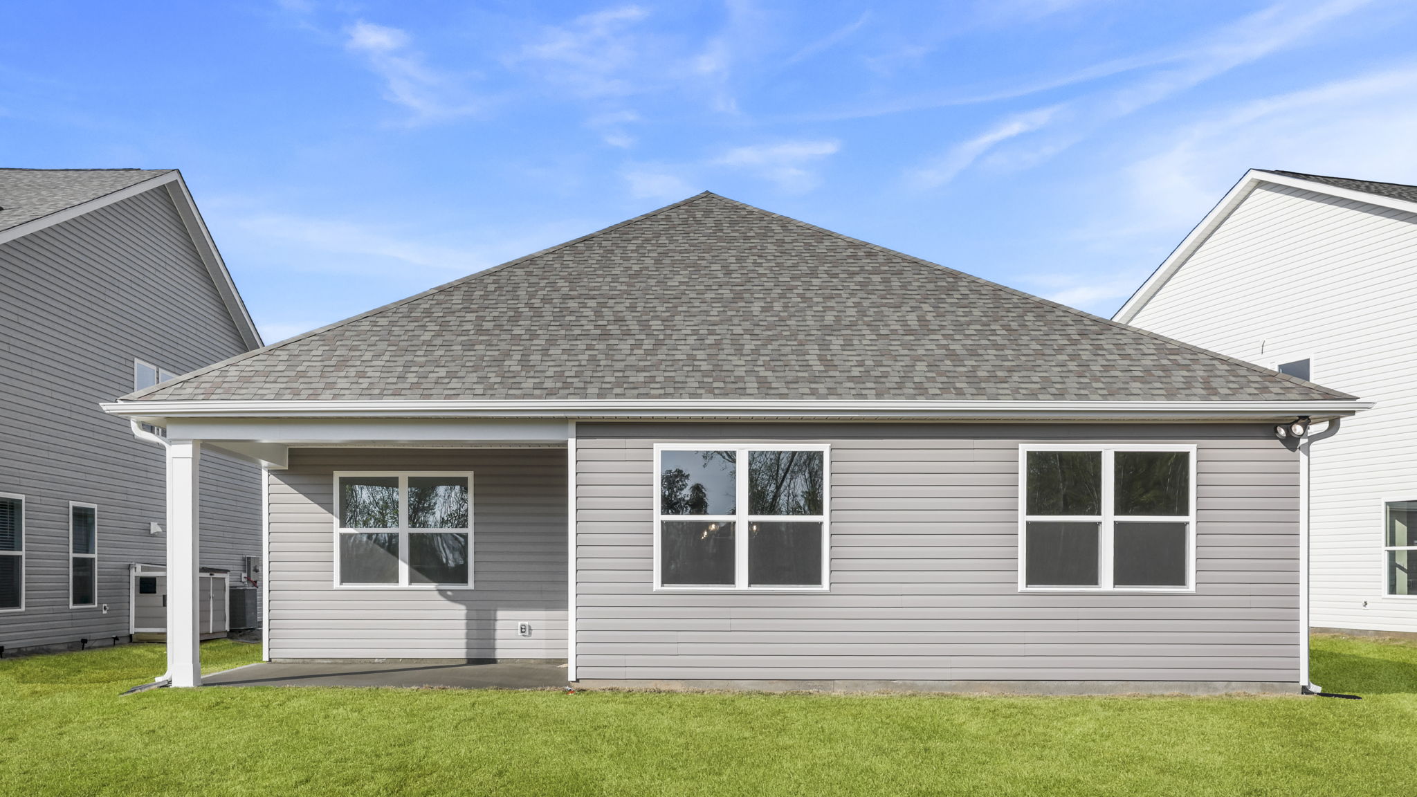 Back exterior of home with large backyard.