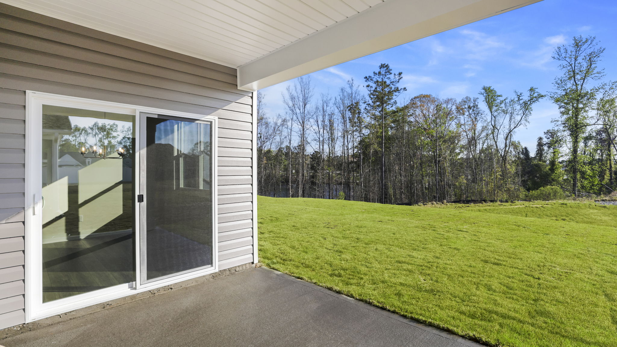 Back exterior of home with patio.