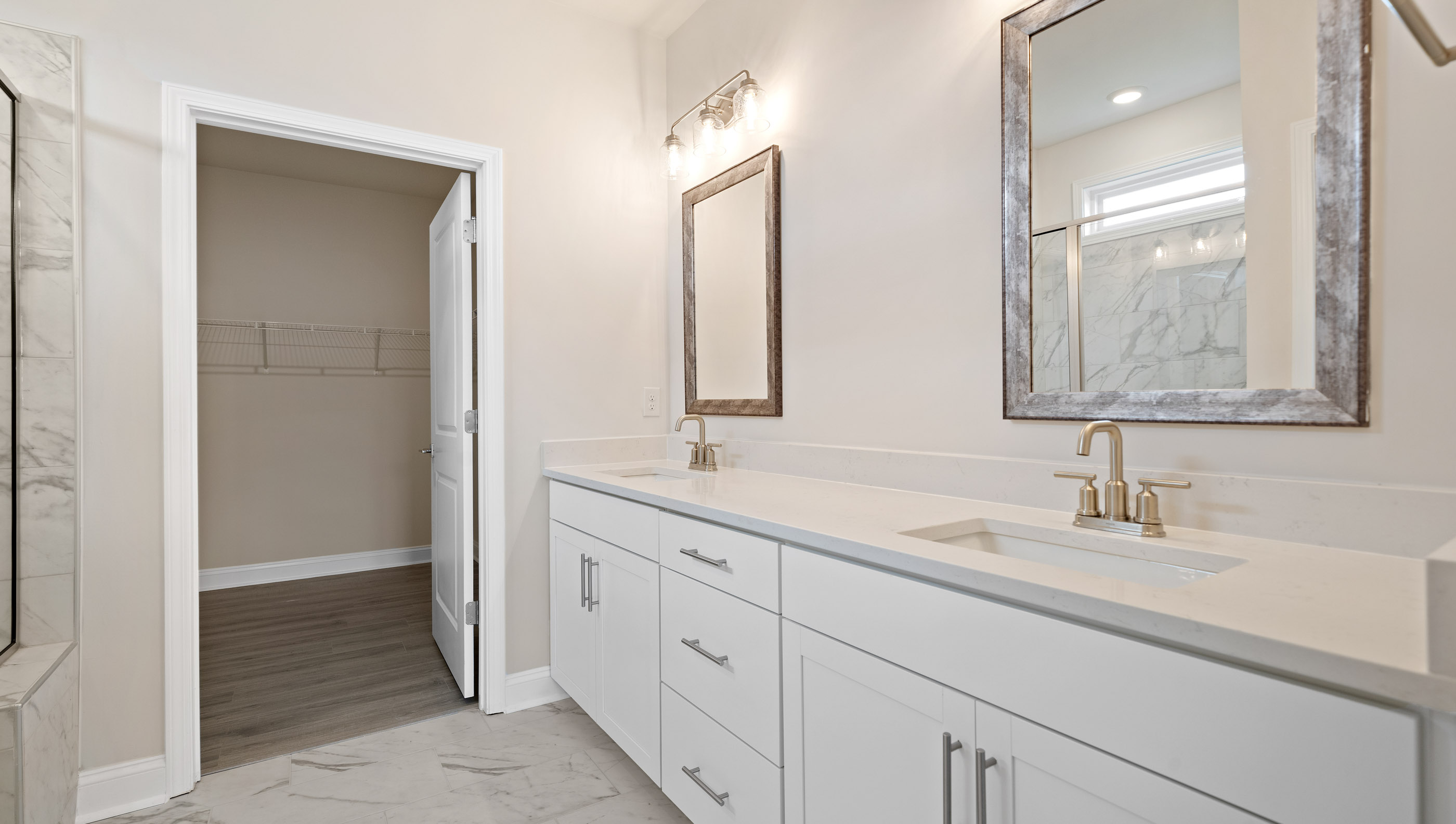 Bathroom with double vanity sink and closet.