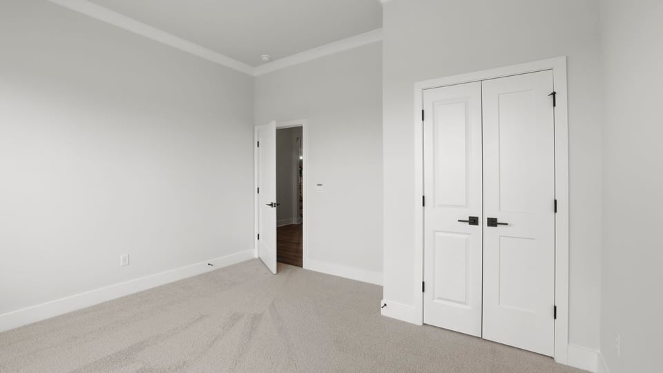 Bedroom with carpet and window.