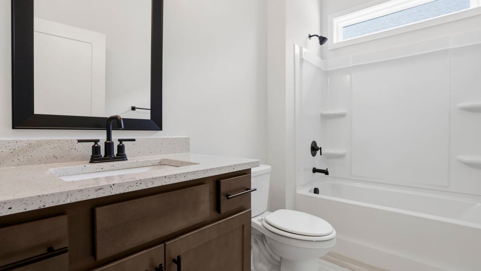 Bathroom with single vanity sink and bathtub.
