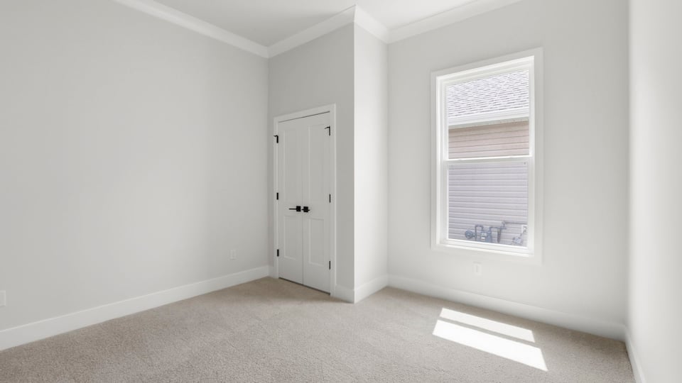 Bedroom with carpet and window/.