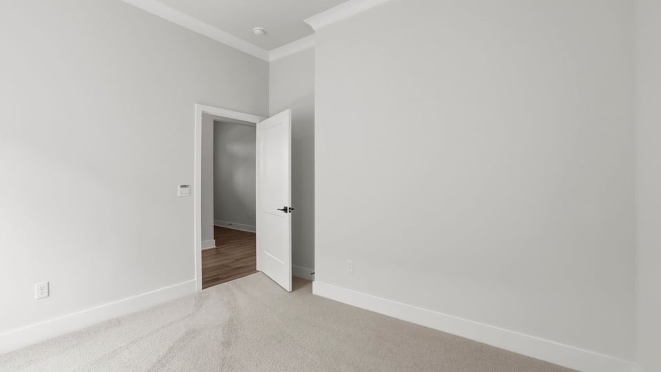 Bedroom with carpet and window/.