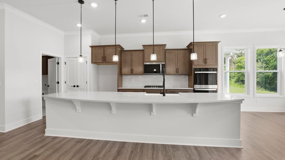 Kitchen and island with quartz countertops.