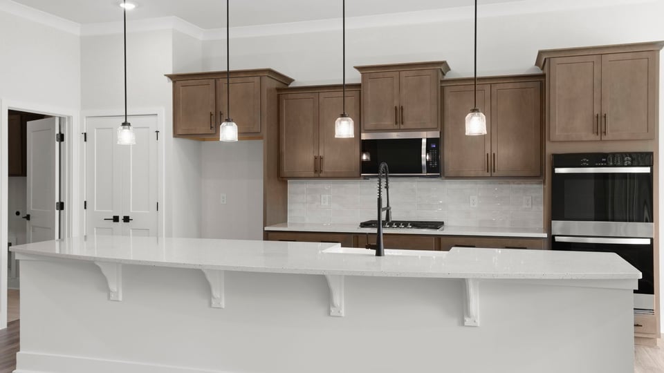 Kitchen and island with quartz countertops.