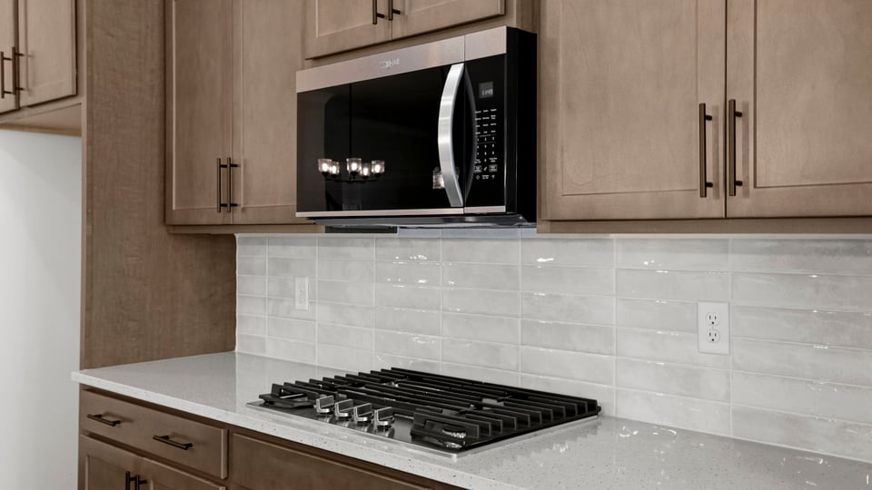 Kitchen and island with quartz countertops.