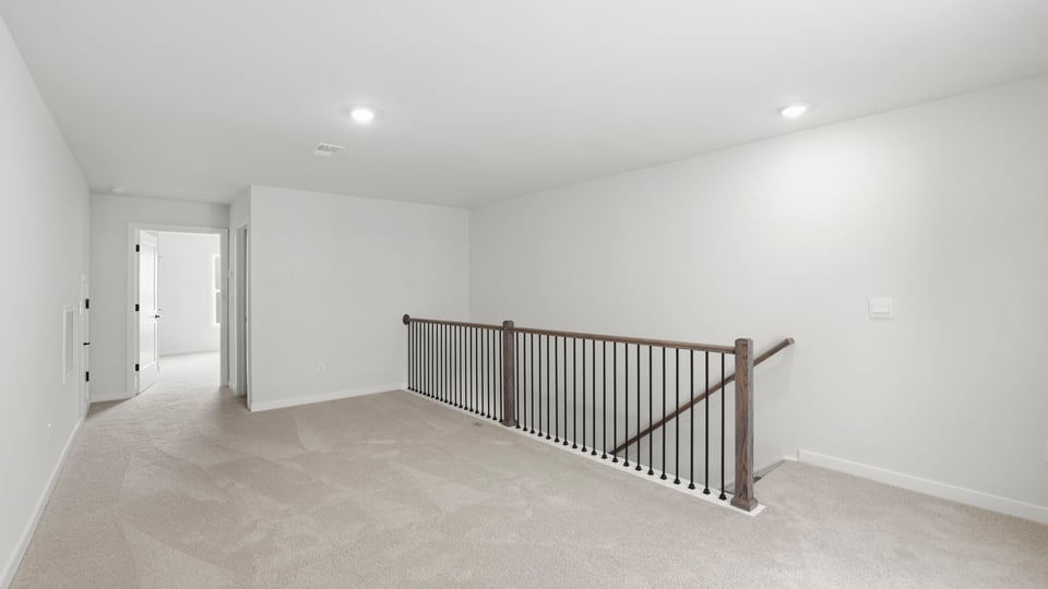 Loft area with carpet.