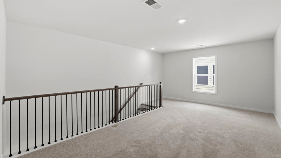 Loft area with carpet.