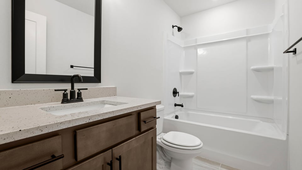 Bathroom with single vanity sink and bathtub.