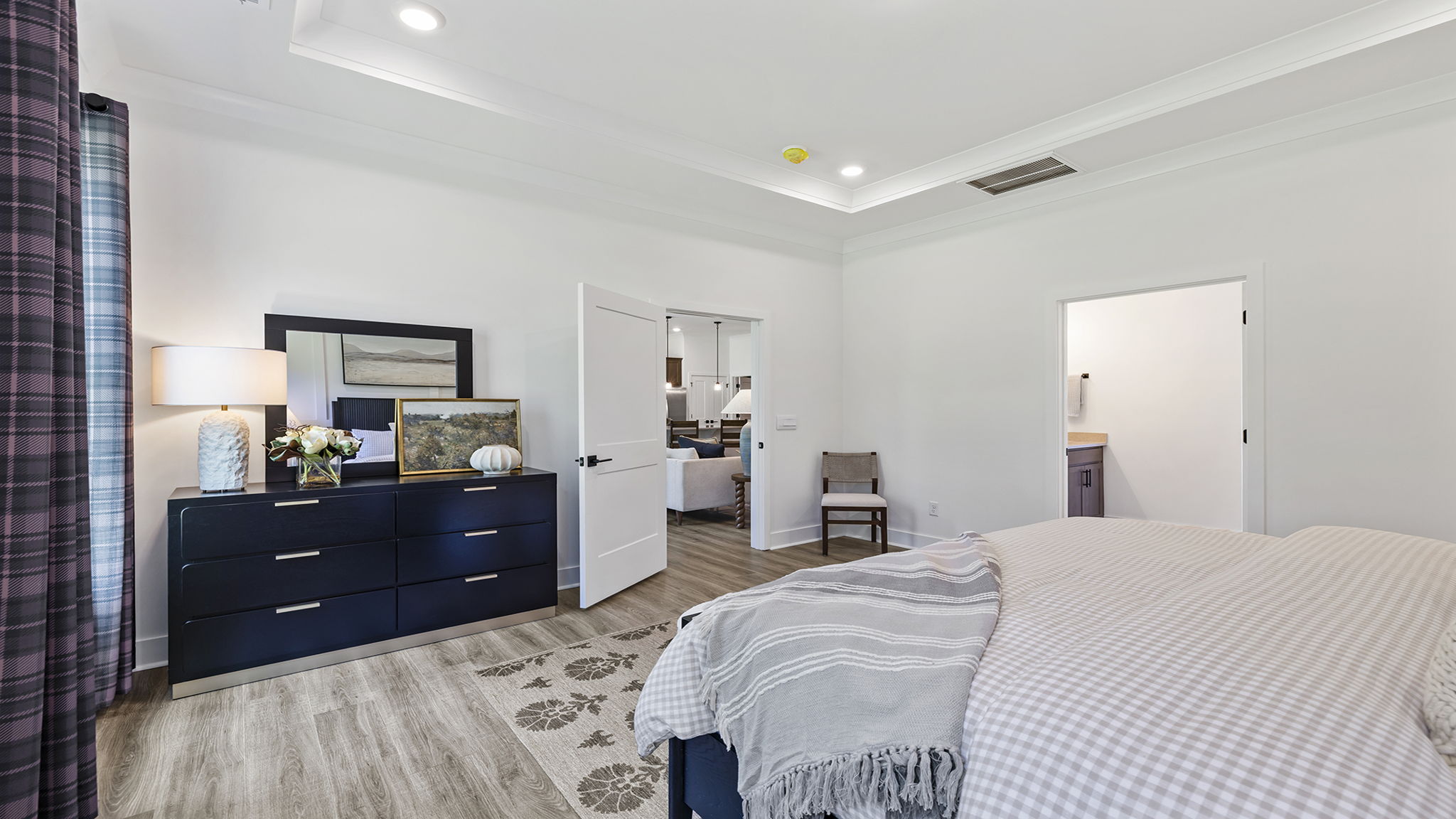 Primary bedroom on main level with trey ceiling.