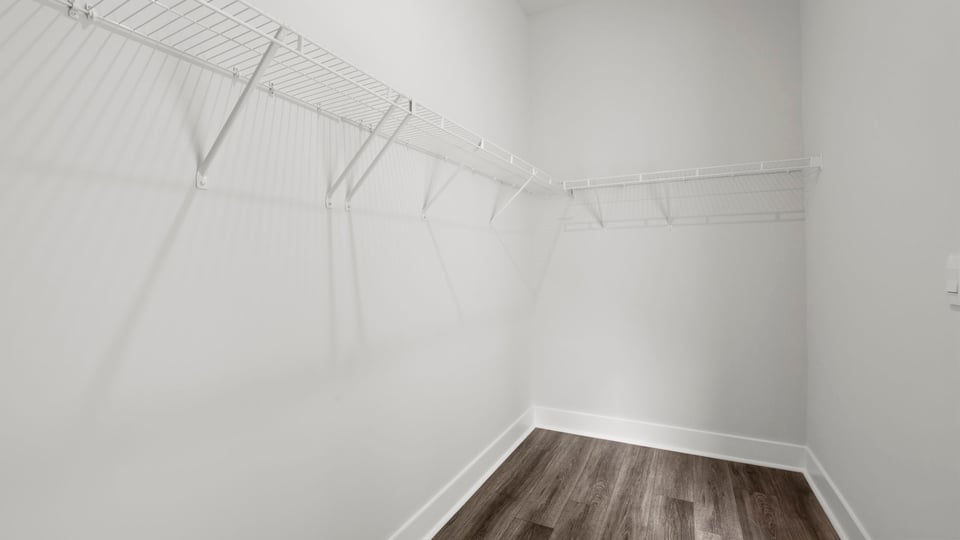 Closet with hanging storage racks.
