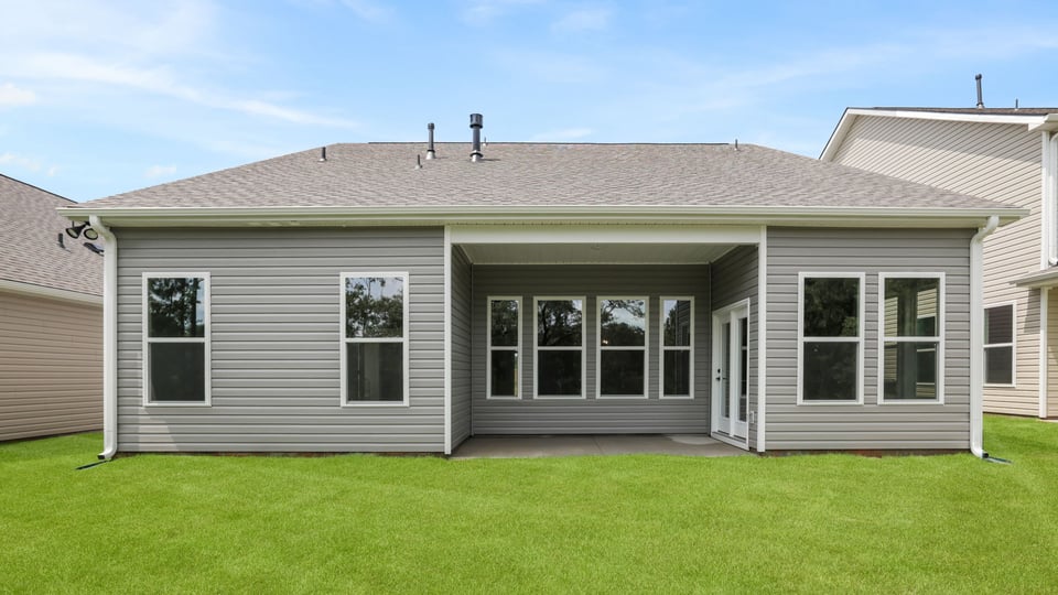 Back exterior of home with large backyard.