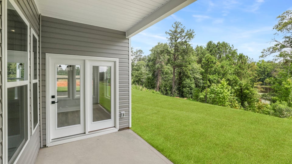 Back exterior of home with small patio.