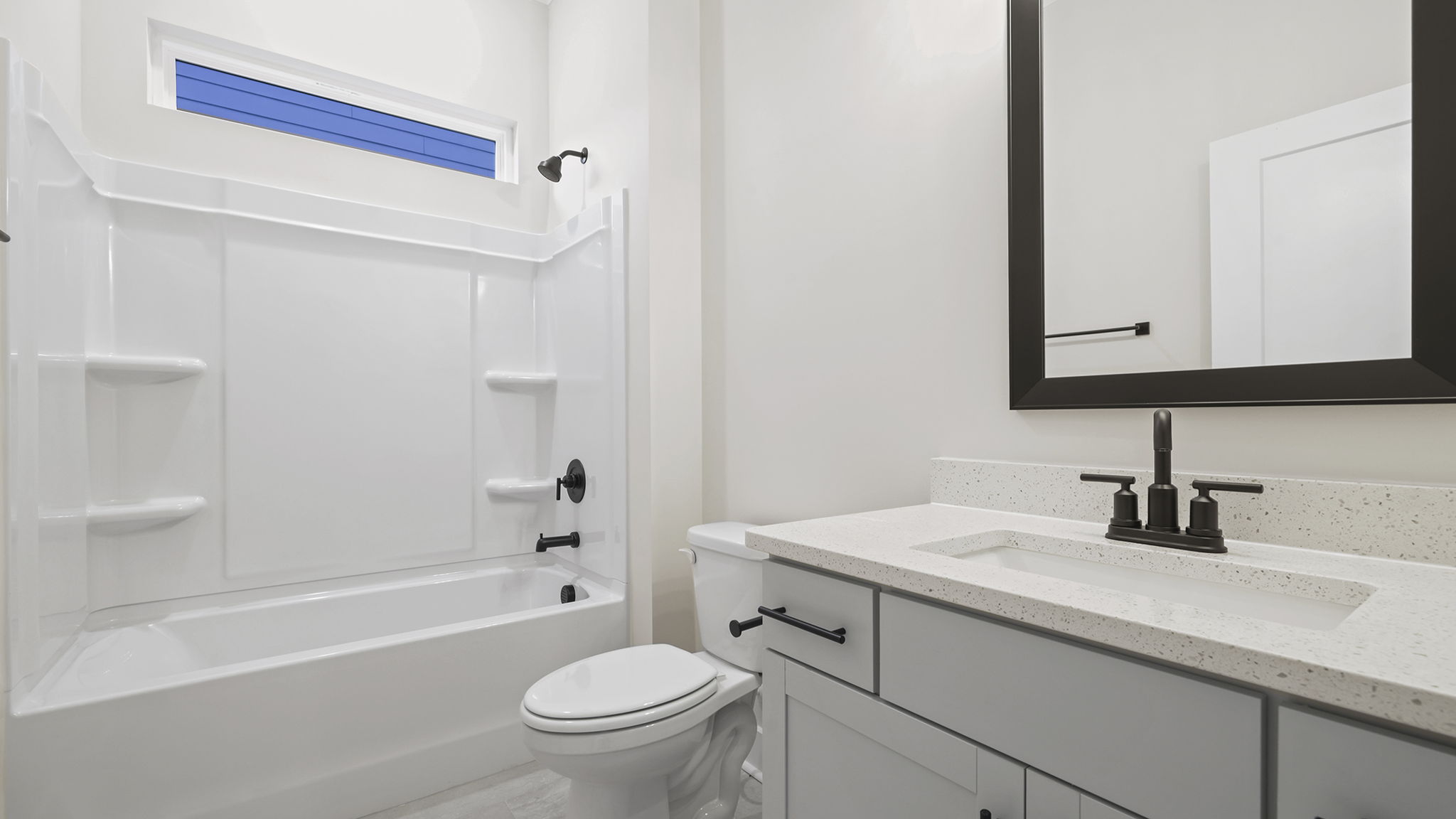Hall bathroom with vanity and combination shower / tub.
