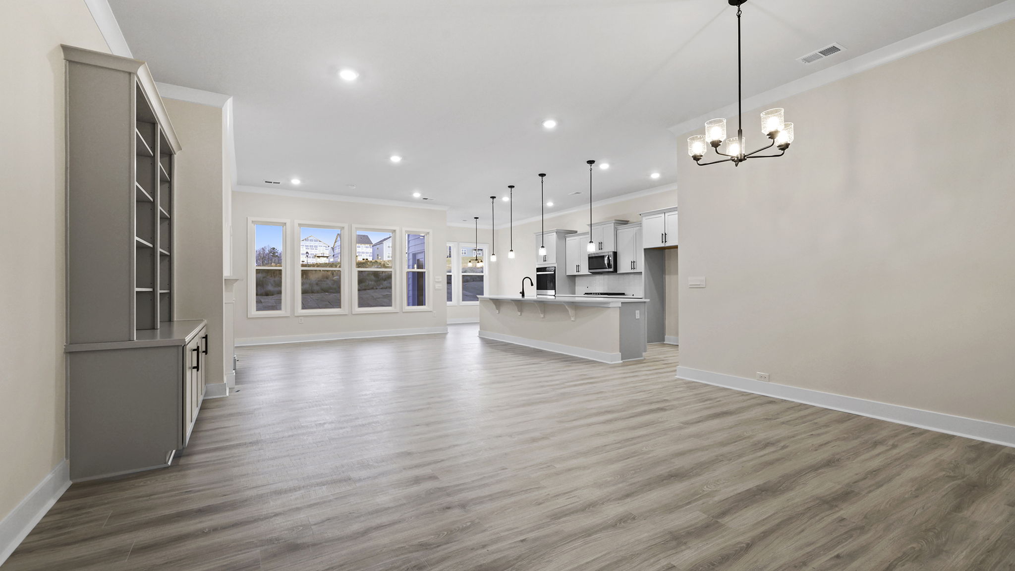View from dining area of the open floor plan with lots of windows.