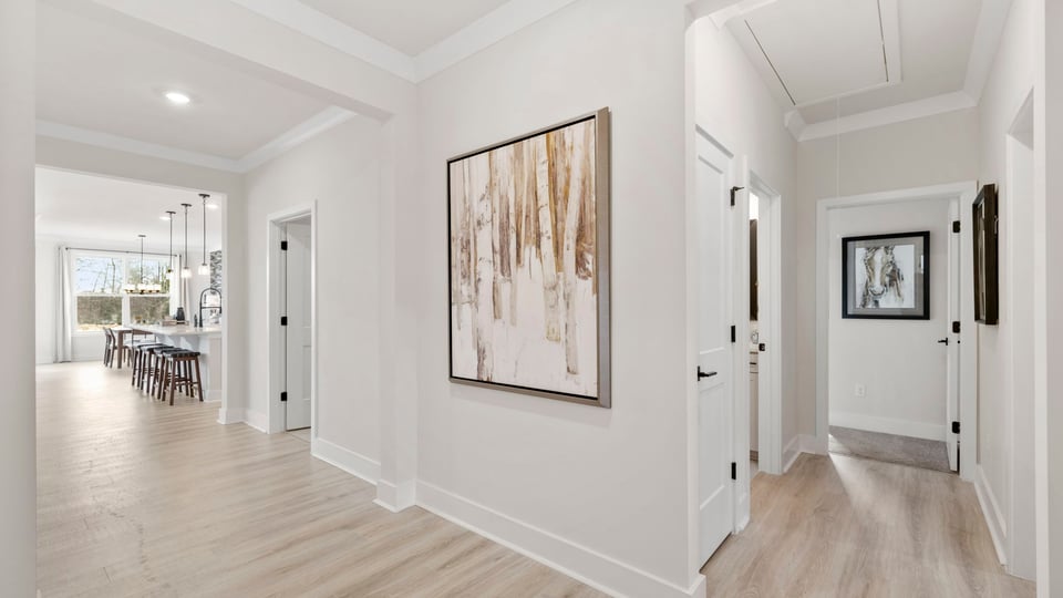 Hallway into home with view of rooms.