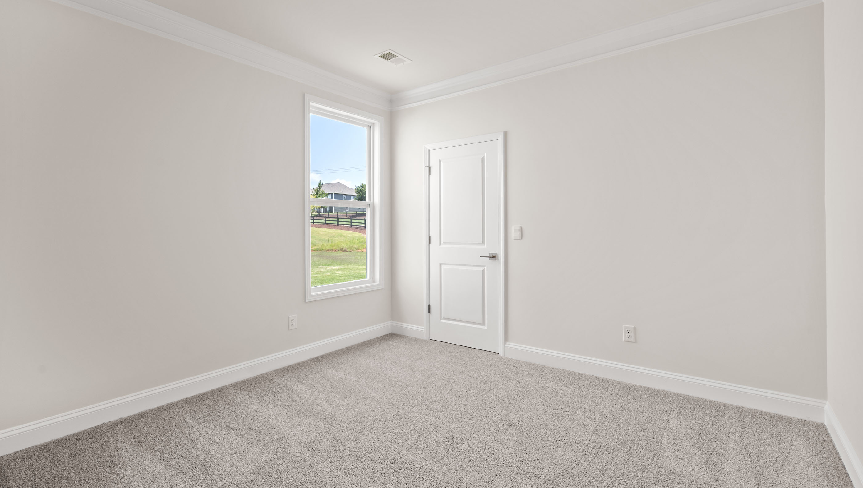 Bedroom with carpet and windows.