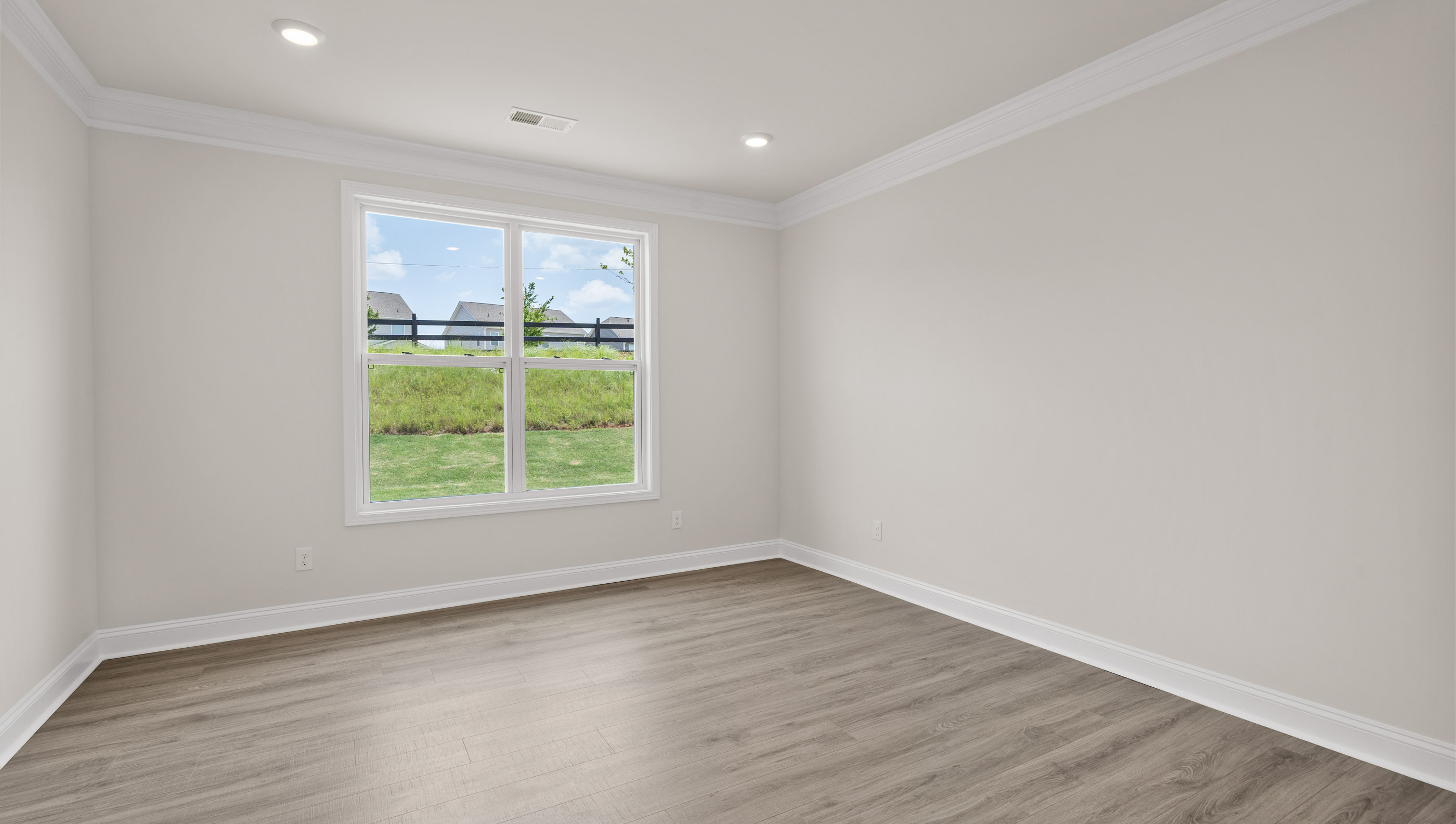 Primary bedroom with windows.