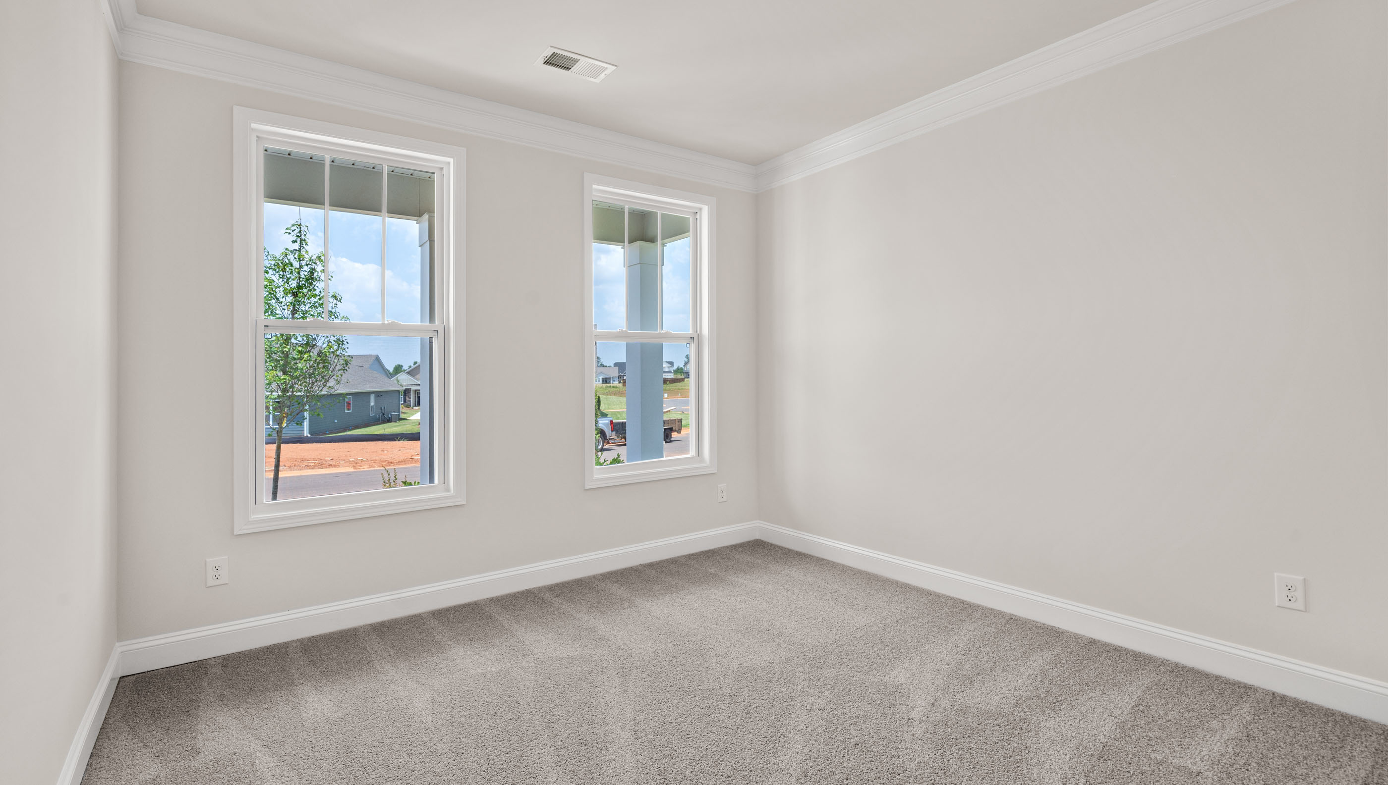 Bedroom with carpet and windows.