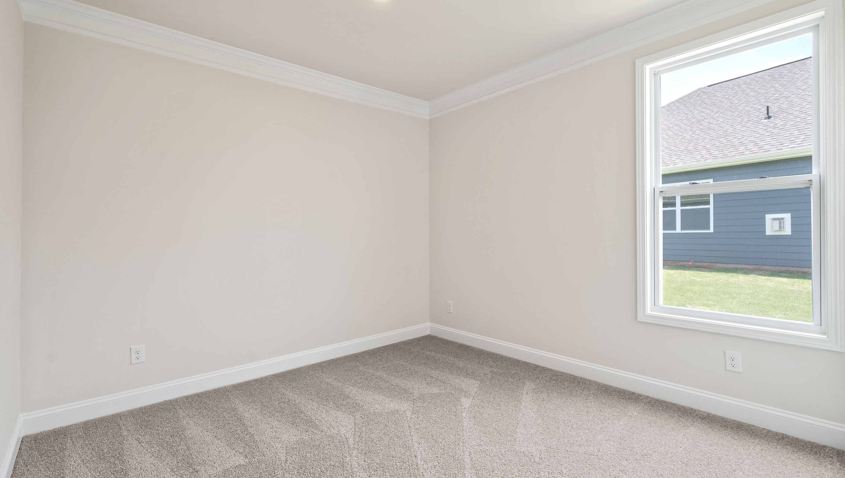 Bedroom with carpet and windows.
