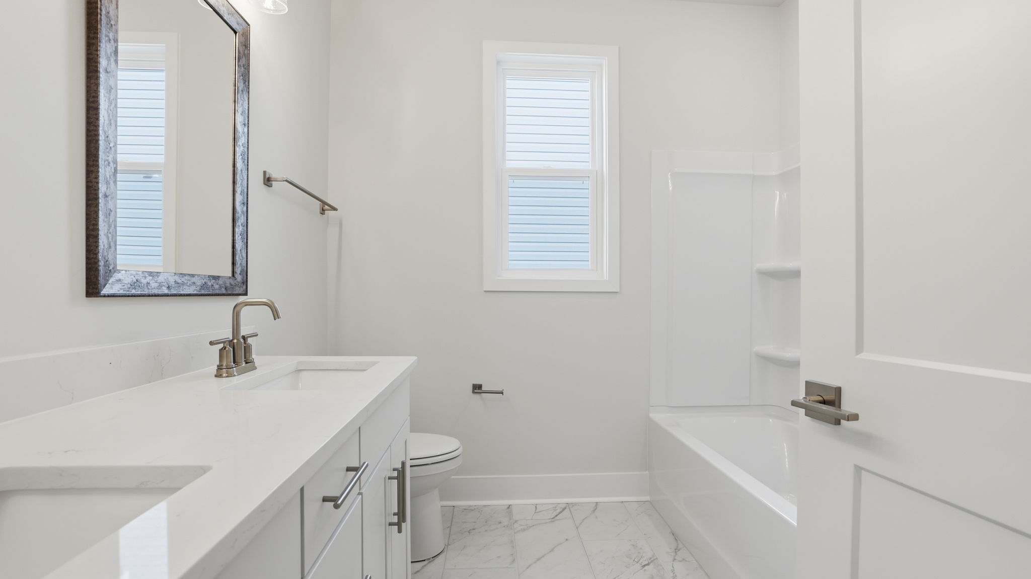 Hall bathroom with vanity and combination shower / tub.