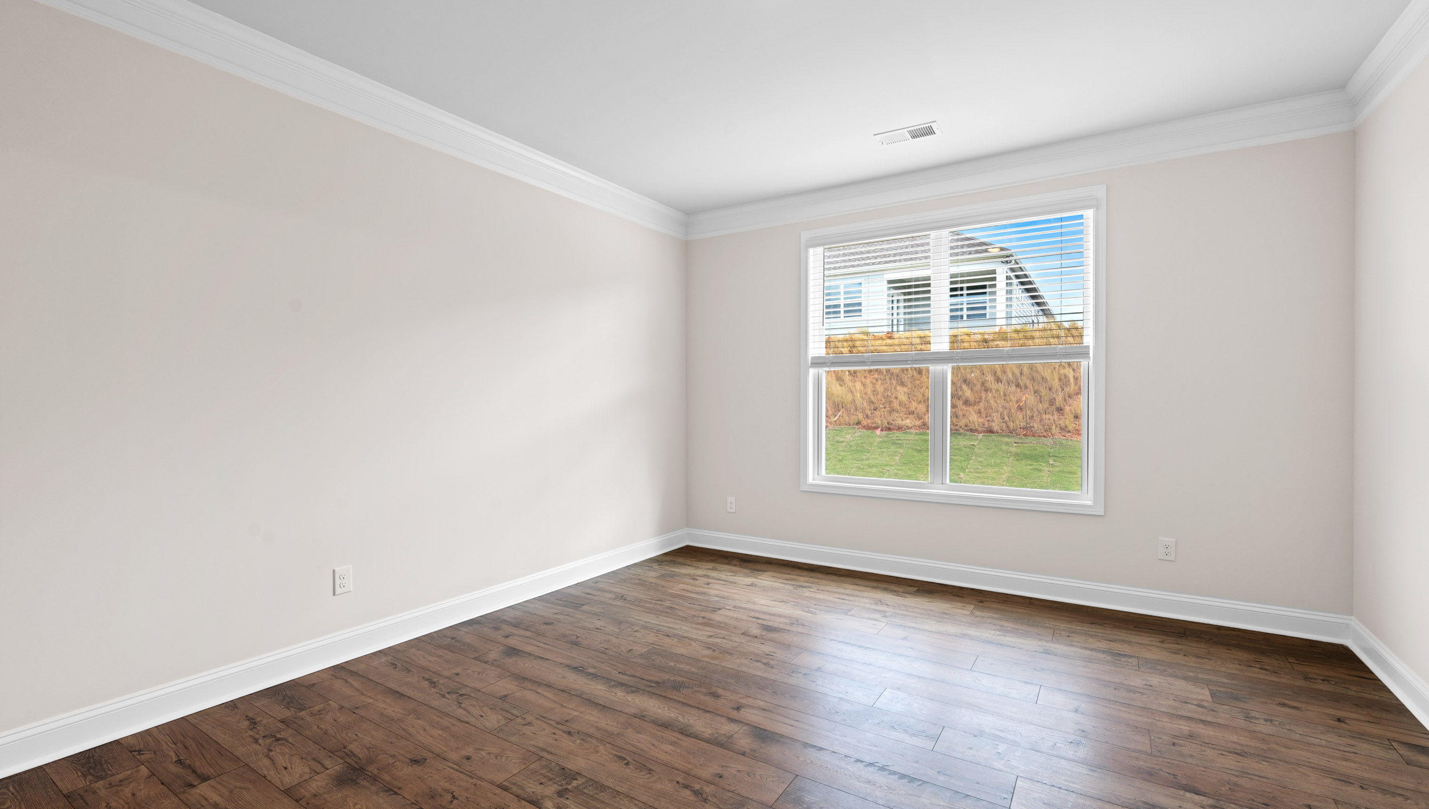 Bedroom with carpet and window.