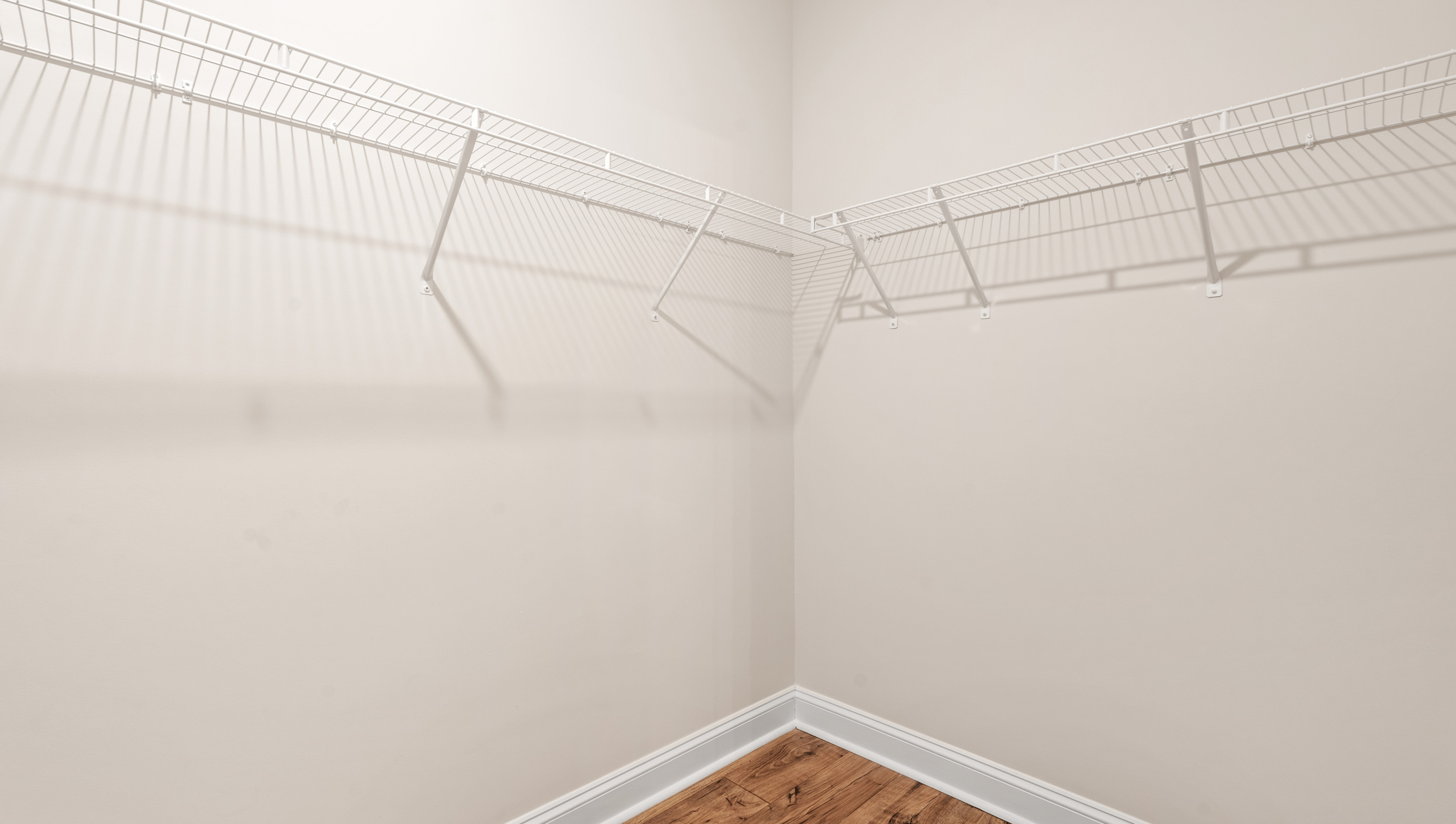 Closet with hanging storage racks.