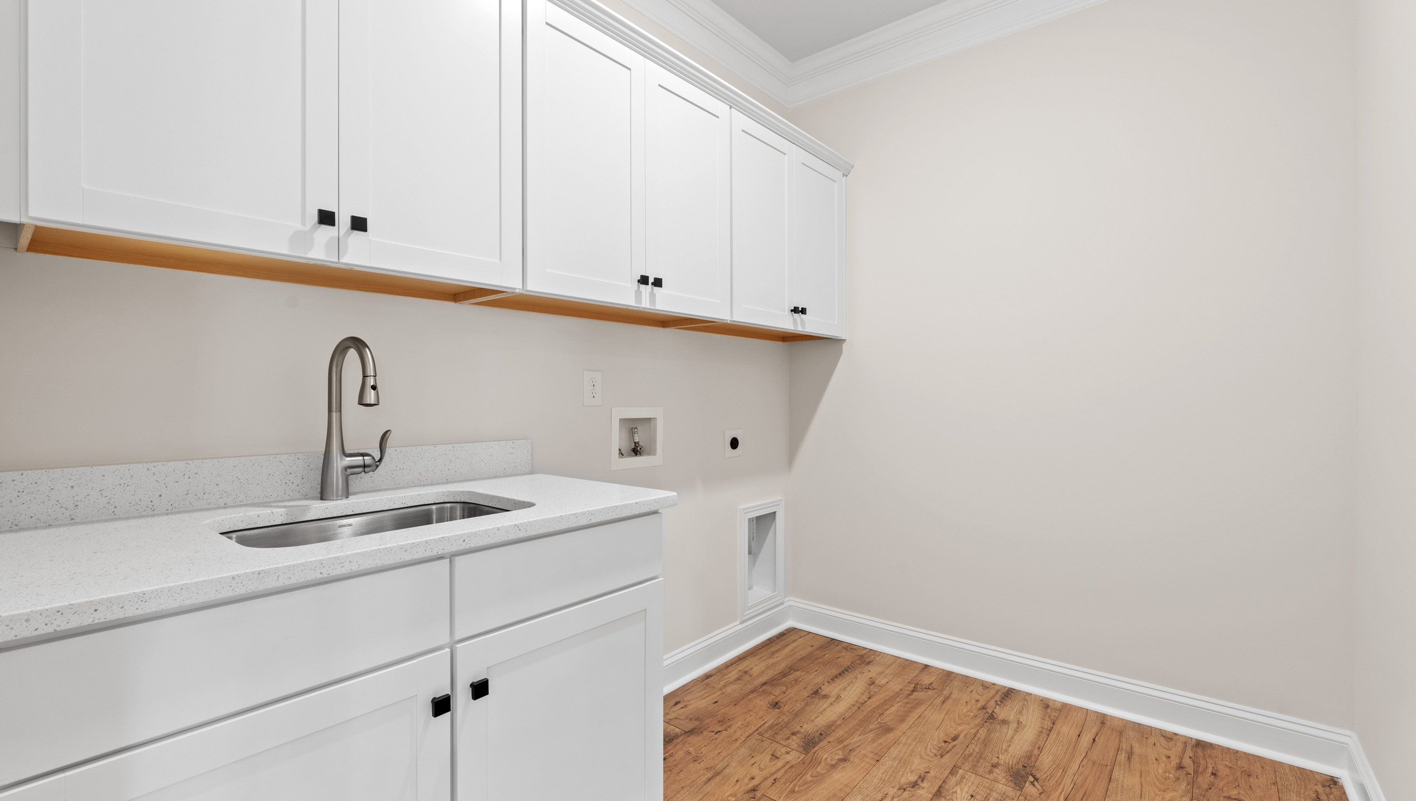 Laundry room with cabinets.