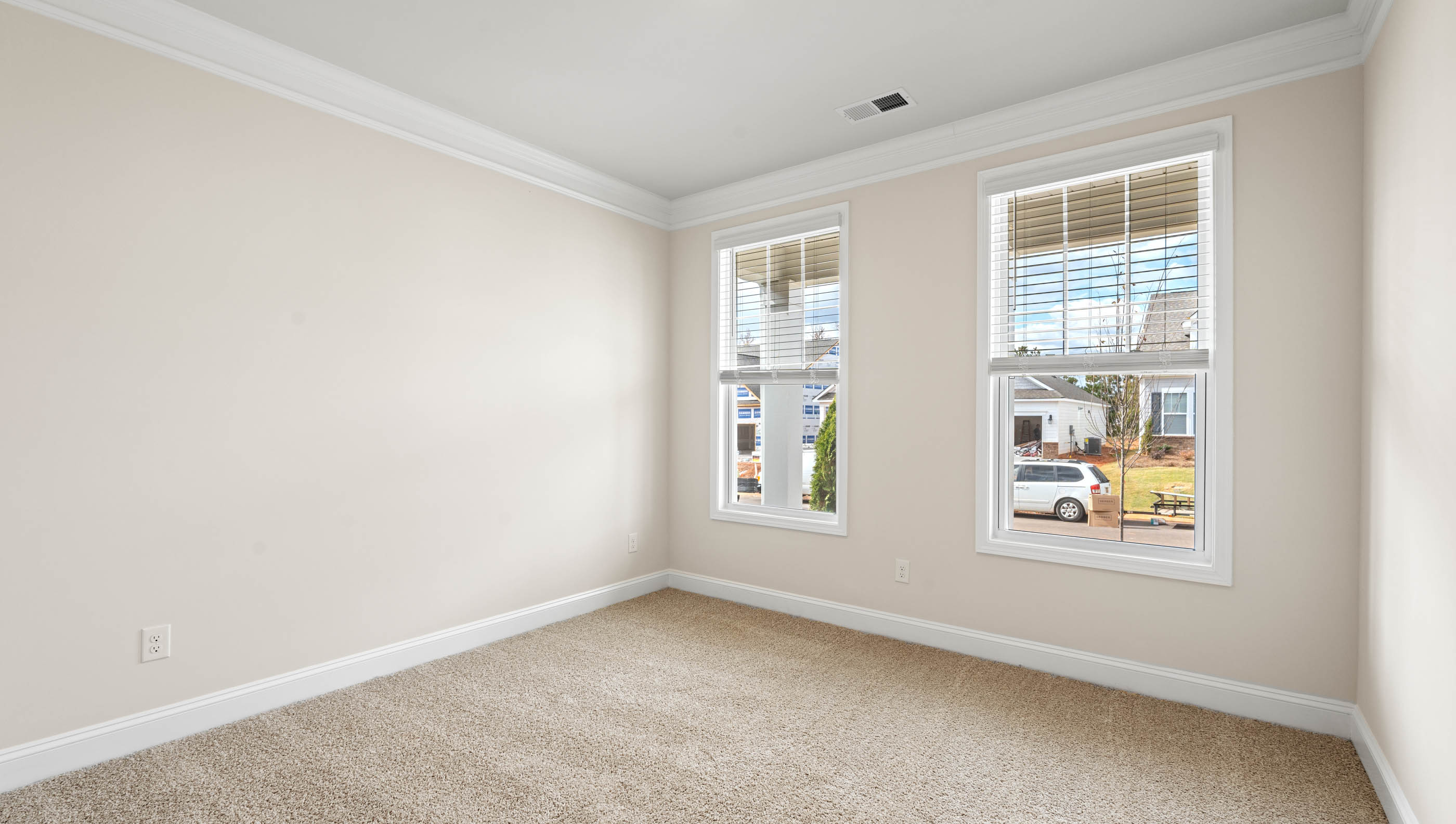 Bedroom with carpet and window.