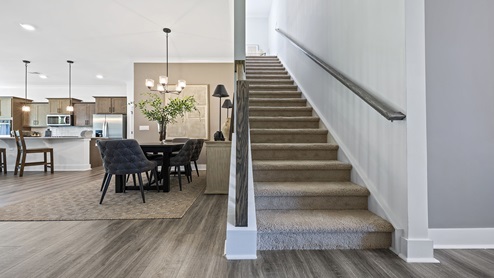 Formal dining area with view of stairs.