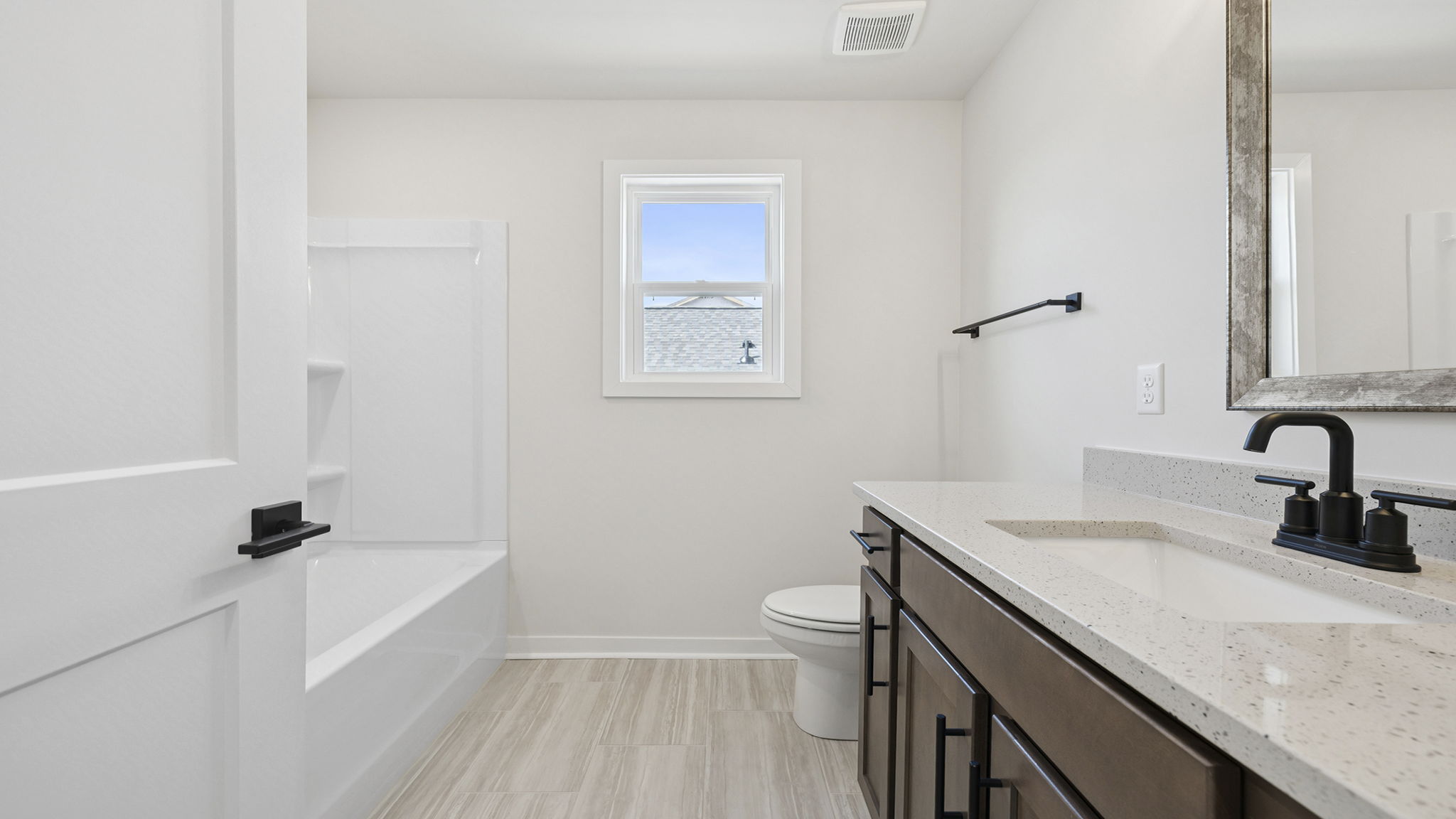 Hall bathroom with vanity and shower / tub.