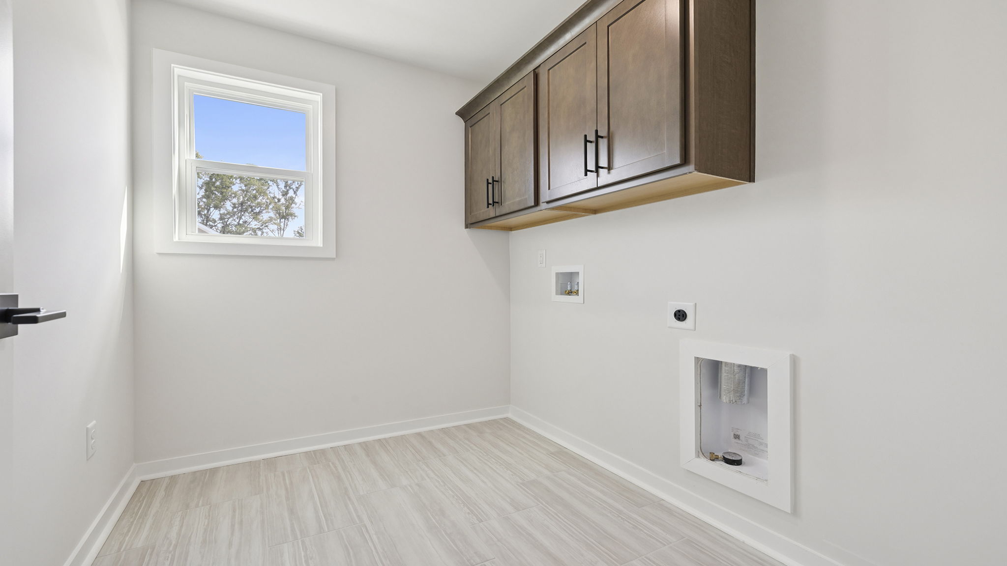 Laundry room with cabinets.