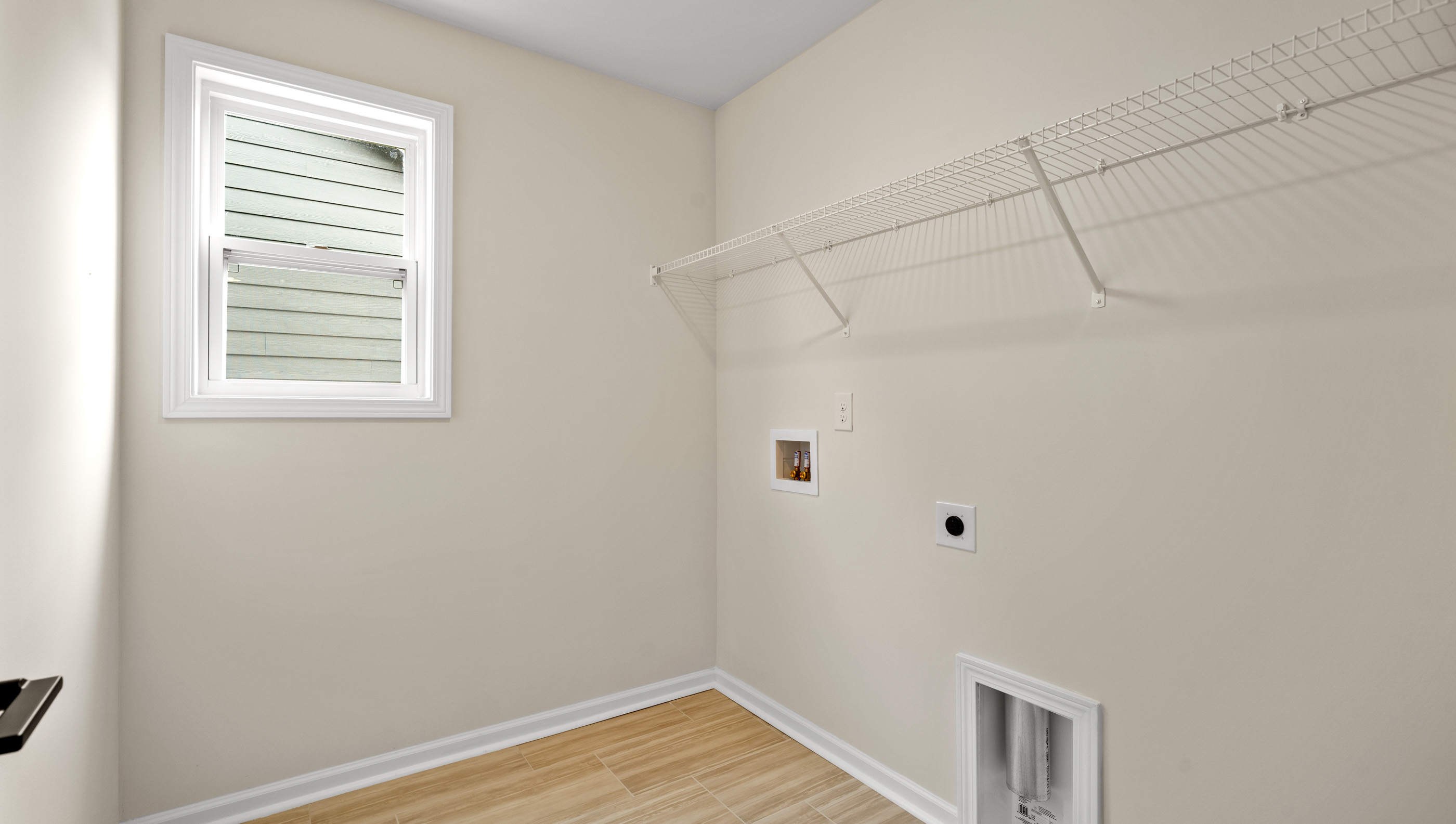Laundry room with hanging storage racks.