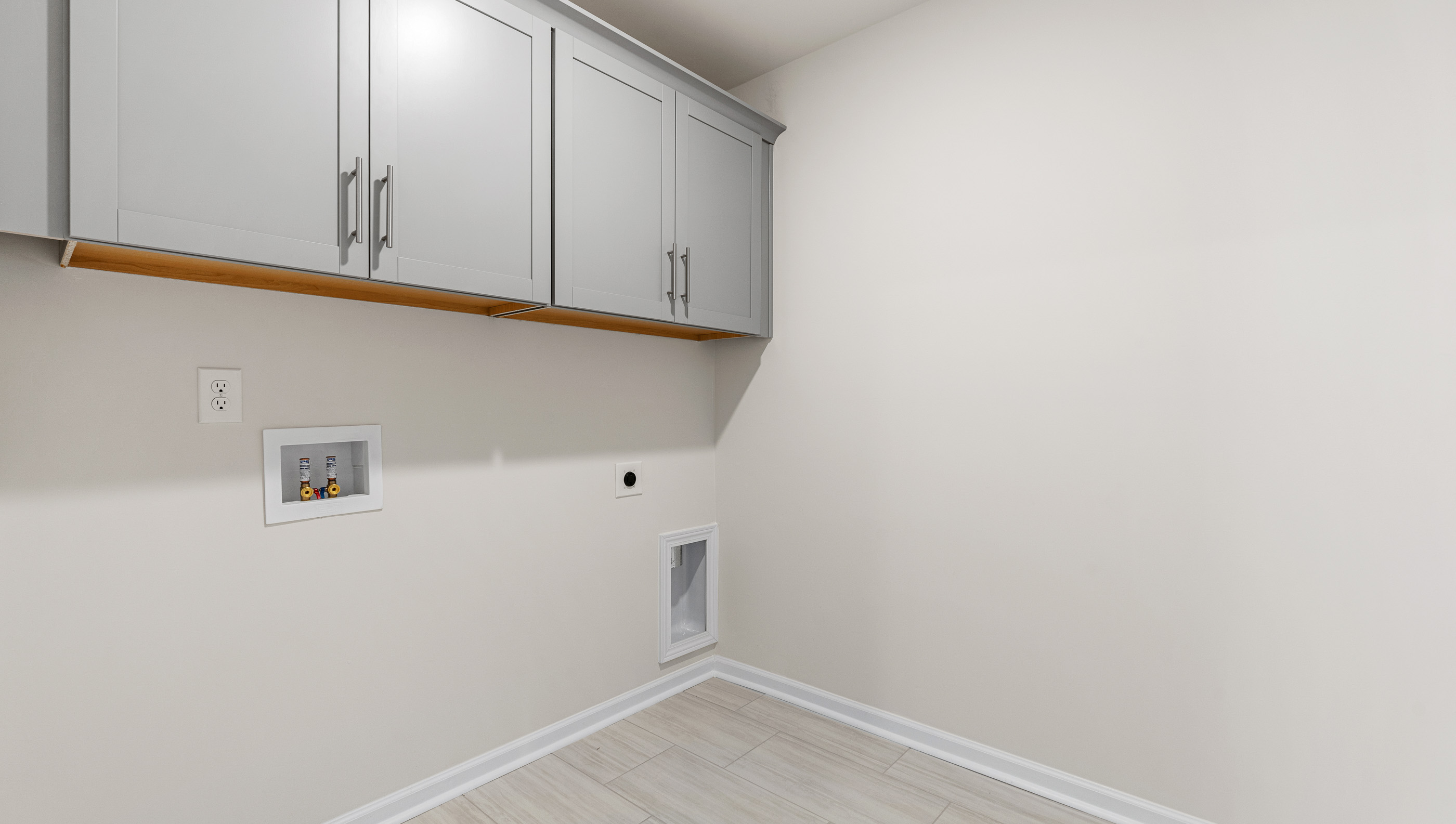 Laundry room with cabinets.