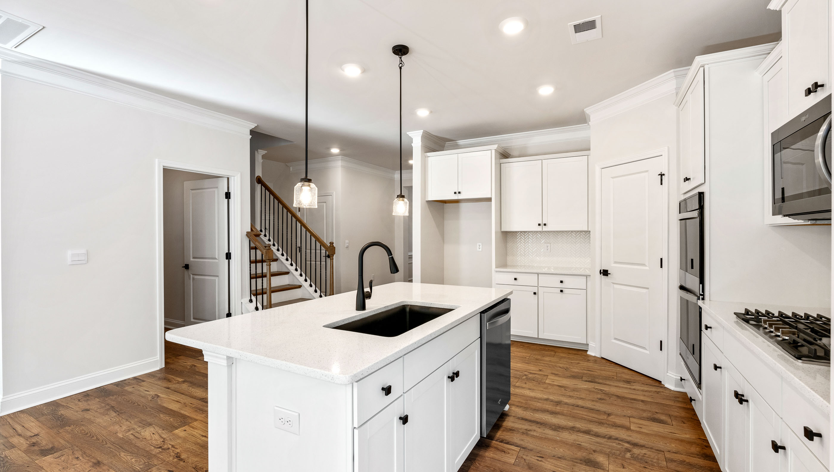 Kitchen and island with granite counter tops.