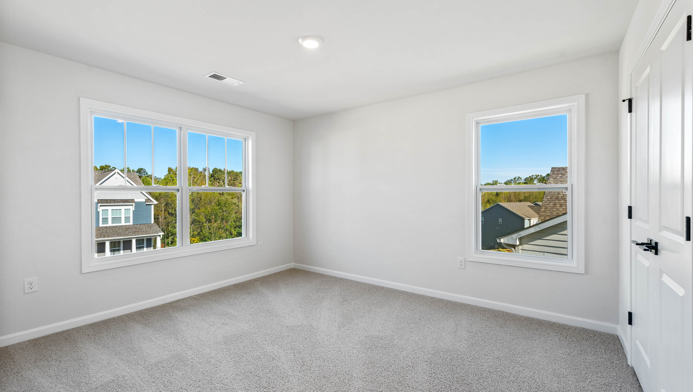 Bedroom with carpet and window.