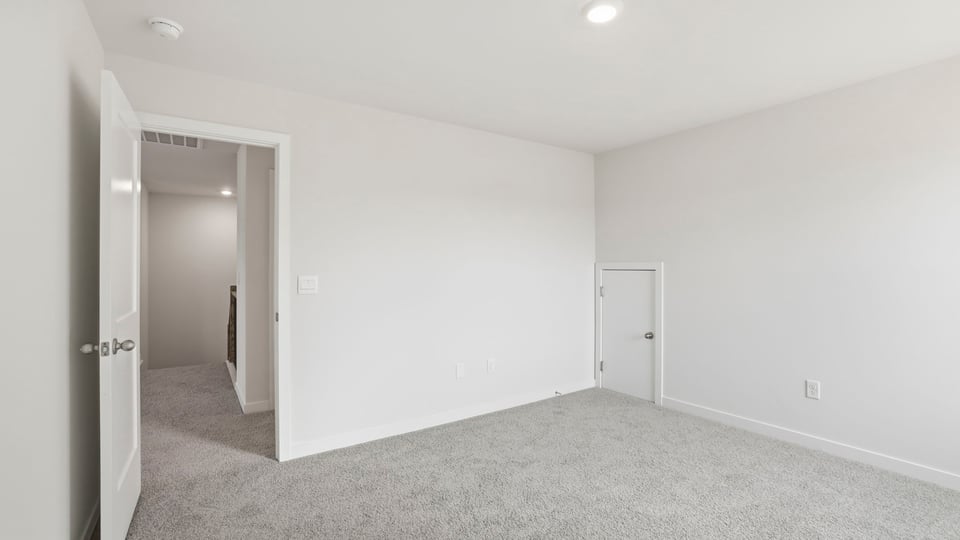 Primary bedroom with windows and trey ceiling.