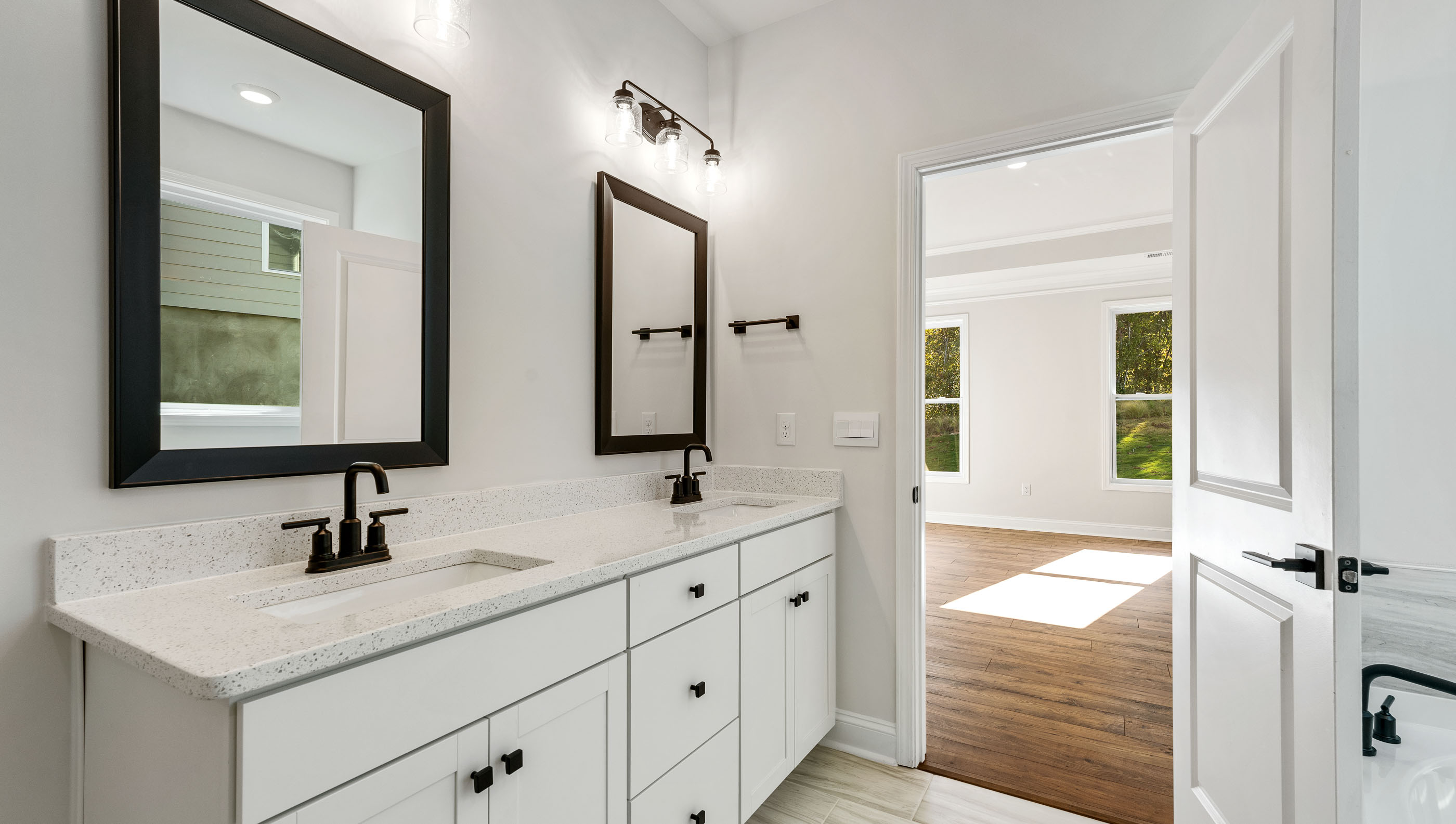 Bathroom with double vanity sink and walk in closet.