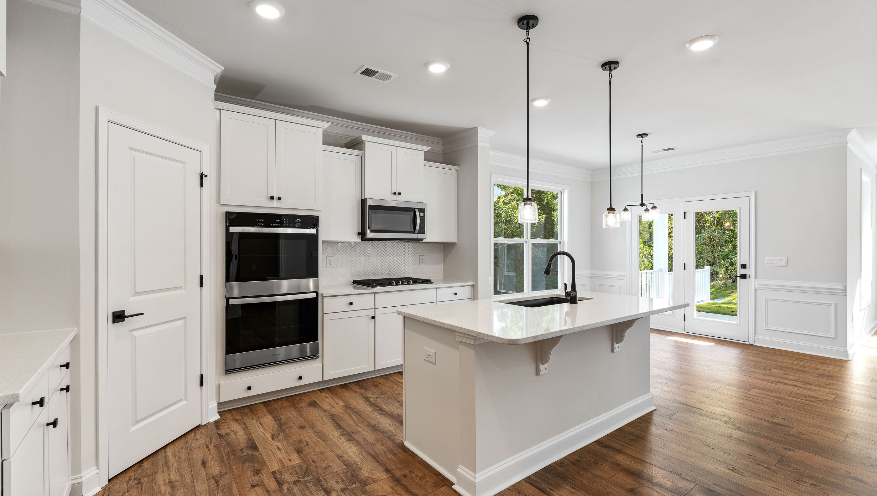 Kitchen and island with granite counter tops.