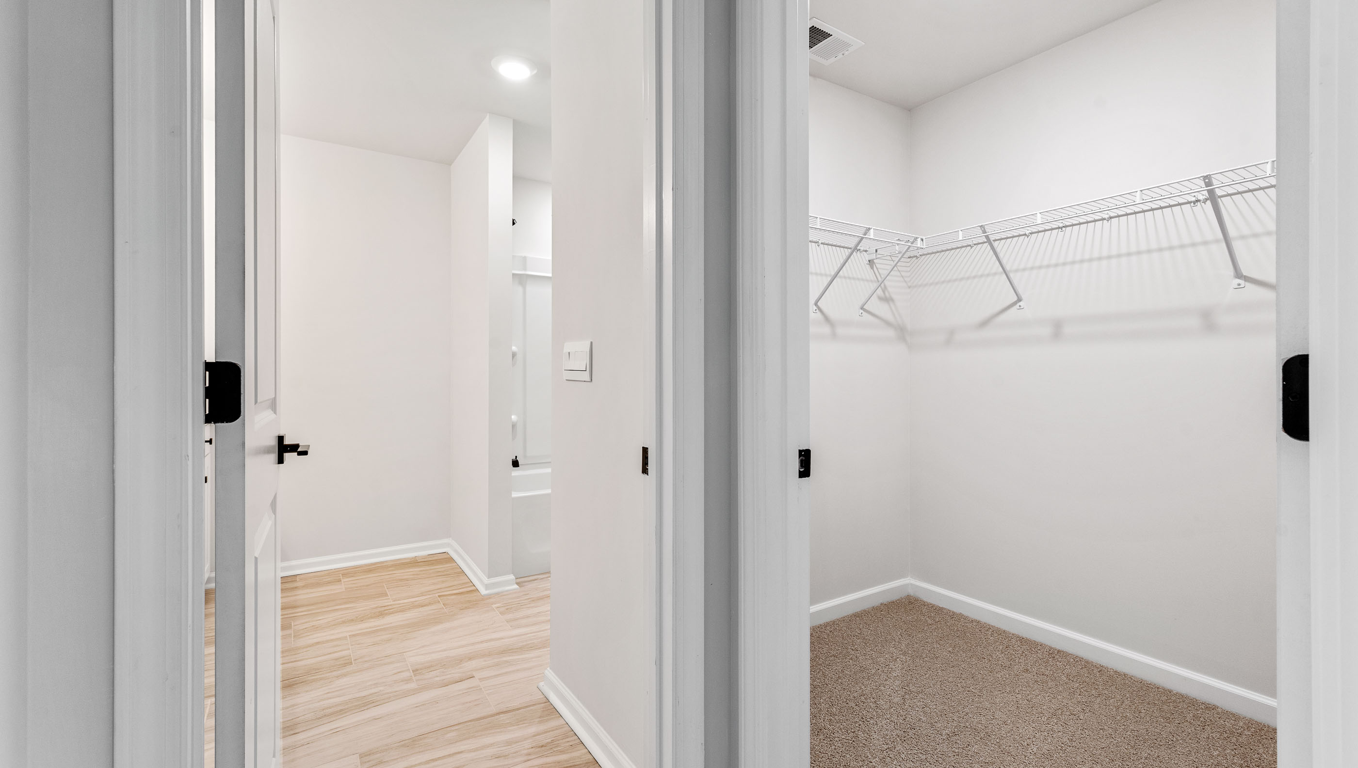 Closet with hanging storage shelves.